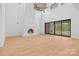 Bright living room boasts high ceilings, fireplace, and large sliding glass doors leading to an outdoor space at 4208 Antioch Church Rd # 1, Weddington, NC 28104