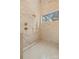 Luxurious walk-in shower featuring stone walls, sleek tile flooring, bronze fixtures, and a window providing natural light at 4208 Antioch Church Rd # 1, Weddington, NC 28104