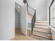 Bright staircase featuring wooden steps with white risers and a sleek black metal railing at 4208 Antioch Church Rd # 1, Weddington, NC 28104