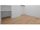 Simple walk-in closet features wood floors, white walls and shelving, creating an organized space at 4208 Antioch Church Rd # 1, Weddington, NC 28104