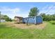 View of the backyard of a blue house with a covered wooden deck at 4351 Saluda Rd, Rock Hill, SC 29730