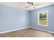 A bright room with a ceiling fan and wood-look floors, offering a view through the window at 4351 Saluda Rd, Rock Hill, SC 29730