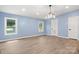 Light-filled bedroom featuring modern lighting, light wood-look flooring, and a large window at 4351 Saluda Rd, Rock Hill, SC 29730