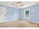 Bright bedroom featuring a ceiling fan, light wood-look floors and a window at 4351 Saluda Rd, Rock Hill, SC 29730