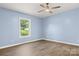 A well-lit room with a window and ceiling fan, complemented by wood-look flooring at 4351 Saluda Rd, Rock Hill, SC 29730