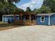 Blue home featuring a welcoming, covered front porch, ample parking and mature shade trees at 4351 Saluda Rd, Rock Hill, SC 29730