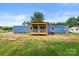 Exterior view of a blue house with a spacious back yard and covered porch at 4351 Saluda Rd, Rock Hill, SC 29730
