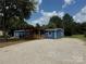 Charming blue home featuring a welcoming, covered front porch and ample gravel parking at 4351 Saluda Rd, Rock Hill, SC 29730