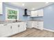 Modern kitchen featuring white cabinets, granite countertops and a black vent hood at 4351 Saluda Rd, Rock Hill, SC 29730