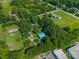 The landscape features a house nestled amongst verdant trees, with structures, roads, and fields stretching out at 4534 Pebblebrook Sw Cir, Concord, NC 28027