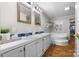 Bright bathroom featuring double vanity, soaking tub, wood-look flooring, and stylish fixtures at 4534 Pebblebrook Sw Cir, Concord, NC 28027