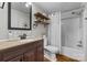 Classic bathroom featuring a shower-tub combo, dark wood vanity, and wood-look floors at 4534 Pebblebrook Sw Cir, Concord, NC 28027
