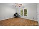 Home office featuring wood-look floors, bright windows and a ceiling fan at 4534 Pebblebrook Sw Cir, Concord, NC 28027