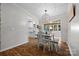 Dining room with modern chandelier and backyard views next to kitchen at 4534 Pebblebrook Sw Cir, Concord, NC 28027