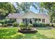 Charming single-story home with well-manicured lawn, fountain, and inviting front porch at 4534 Pebblebrook Sw Cir, Concord, NC 28027