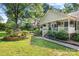 Beautiful home with lush landscaping, garden water feature, and inviting front porch at 4534 Pebblebrook Sw Cir, Concord, NC 28027