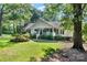 Charming single-story home featuring a water fountain, a covered porch, and beautiful landscaping at 4534 Pebblebrook Sw Cir, Concord, NC 28027