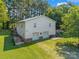 Two-story garage with two garage doors, brick detail and stairs to an upper level on a sunny, green lot at 4534 Pebblebrook Sw Cir, Concord, NC 28027