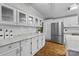 Spacious white kitchen with granite countertops, modern appliances, and ample cabinetry at 4534 Pebblebrook Sw Cir, Concord, NC 28027