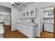 Convenient white laundry room with storage cabinets and adjacent utility space at 4534 Pebblebrook Sw Cir, Concord, NC 28027