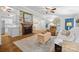 Living room showcasing a fireplace, wood floors, and open layout to dining area at 4534 Pebblebrook Sw Cir, Concord, NC 28027