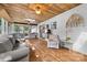 Bright sunroom with wood ceiling, cozy seating, and access to the outdoors at 4534 Pebblebrook Sw Cir, Concord, NC 28027