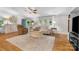 Bright living room boasts hardwood floors, neutral decor, and abundant natural light at 4534 Pebblebrook Sw Cir, Concord, NC 28027