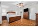 Bedroom featuring a wooden bed frame, ceiling fan, and a door to the bathroom at 4534 Pebblebrook Sw Cir, Concord, NC 28027