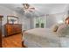 Comfortable bedroom with natural light, ceiling fan, and wood-look floors at 4534 Pebblebrook Sw Cir, Concord, NC 28027