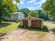 Outbuilding with natural wood doors and a stone driveway set alongside the main residence at 4534 Pebblebrook Sw Cir, Concord, NC 28027