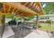 Cozy covered outdoor patio area with comfortable seating, grill and fan, perfect for gatherings at 4534 Pebblebrook Sw Cir, Concord, NC 28027