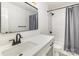 Well-lit bathroom with a modern vanity, large mirror, and a shower-tub combo at 5234 Bellflower Ln, Charlotte, NC 28227