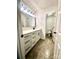 Bright bathroom features white vanity with black hardware, and tiled shower stall at 5234 Bellflower Ln, Charlotte, NC 28227