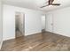 Spacious bedroom with hardwood floors, two entry doors, and a ceiling fan at 5234 Bellflower Ln, Charlotte, NC 28227