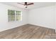 Sunlit bedroom featuring hardwood floors and a large window at 5234 Bellflower Ln, Charlotte, NC 28227