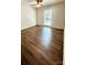 This bedroom boasts gleaming hardwood floors, ceiling fan, and a bright window at 5234 Bellflower Ln, Charlotte, NC 28227