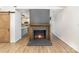Living room features a cozy brick fireplace, wood floors, sliding barn door, and modern lighting at 5234 Bellflower Ln, Charlotte, NC 28227