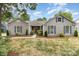 Charming single-story home with gray siding, blue shutters, well-manicured lawn, and inviting walkway at 5234 Bellflower Ln, Charlotte, NC 28227