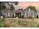 Charming single-story home with gray siding, blue shutters, well-manicured lawn, and inviting walkway at 5234 Bellflower Ln, Charlotte, NC 28227