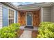 Inviting front porch featuring wood shingle accents, a blue front door, and lush landscaping at 5234 Bellflower Ln, Charlotte, NC 28227
