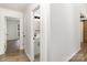 Bright hallway featuring hardwood floors with a view of the bathroom and bedroom at 5234 Bellflower Ln, Charlotte, NC 28227