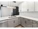 Modern kitchen with stainless steel appliances, gray cabinets, a sleek faucet, and mosaic backsplash at 5234 Bellflower Ln, Charlotte, NC 28227
