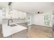 Bright kitchen with white and gray cabinets, stainless steel appliances, and wood flooring at 5234 Bellflower Ln, Charlotte, NC 28227