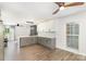 Modern kitchen featuring white and gray cabinets, stainless appliances, mosaic backsplash, and an adjacent dining area at 5234 Bellflower Ln, Charlotte, NC 28227