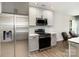 A modern kitchen featuring stainless steel appliances, white countertops, and stylish gray cabinetry at 5234 Bellflower Ln, Charlotte, NC 28227