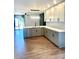 Modern kitchen with stainless steel appliances, white cabinets, and hardwood flooring at 5234 Bellflower Ln, Charlotte, NC 28227
