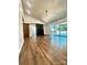 Open living room with a fireplace, hardwood floors, and access to the outdoor deck at 5234 Bellflower Ln, Charlotte, NC 28227