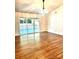 Bright living room with hardwood floors and sliding glass doors leading to a deck at 5234 Bellflower Ln, Charlotte, NC 28227