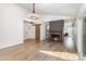 Open living room with a cozy fireplace, wood floors, barn door, and modern lighting at 5234 Bellflower Ln, Charlotte, NC 28227