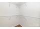 Organized walk-in closet features white wire shelving for ample storage space at 5234 Bellflower Ln, Charlotte, NC 28227